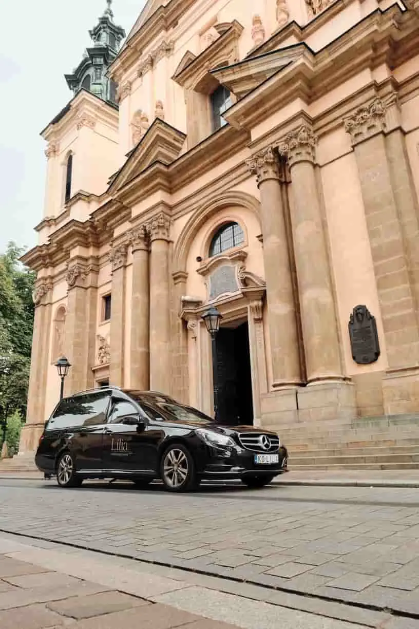A Lilia hearse outside a church