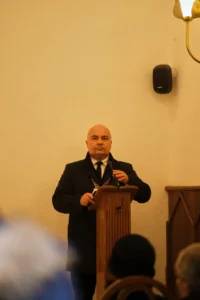 The celebrant at the lectern in a chapel