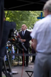 The celebrant at the microphone during a funeral